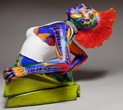 side view of ceramic sculpture of punk chick with colorful surface decoration